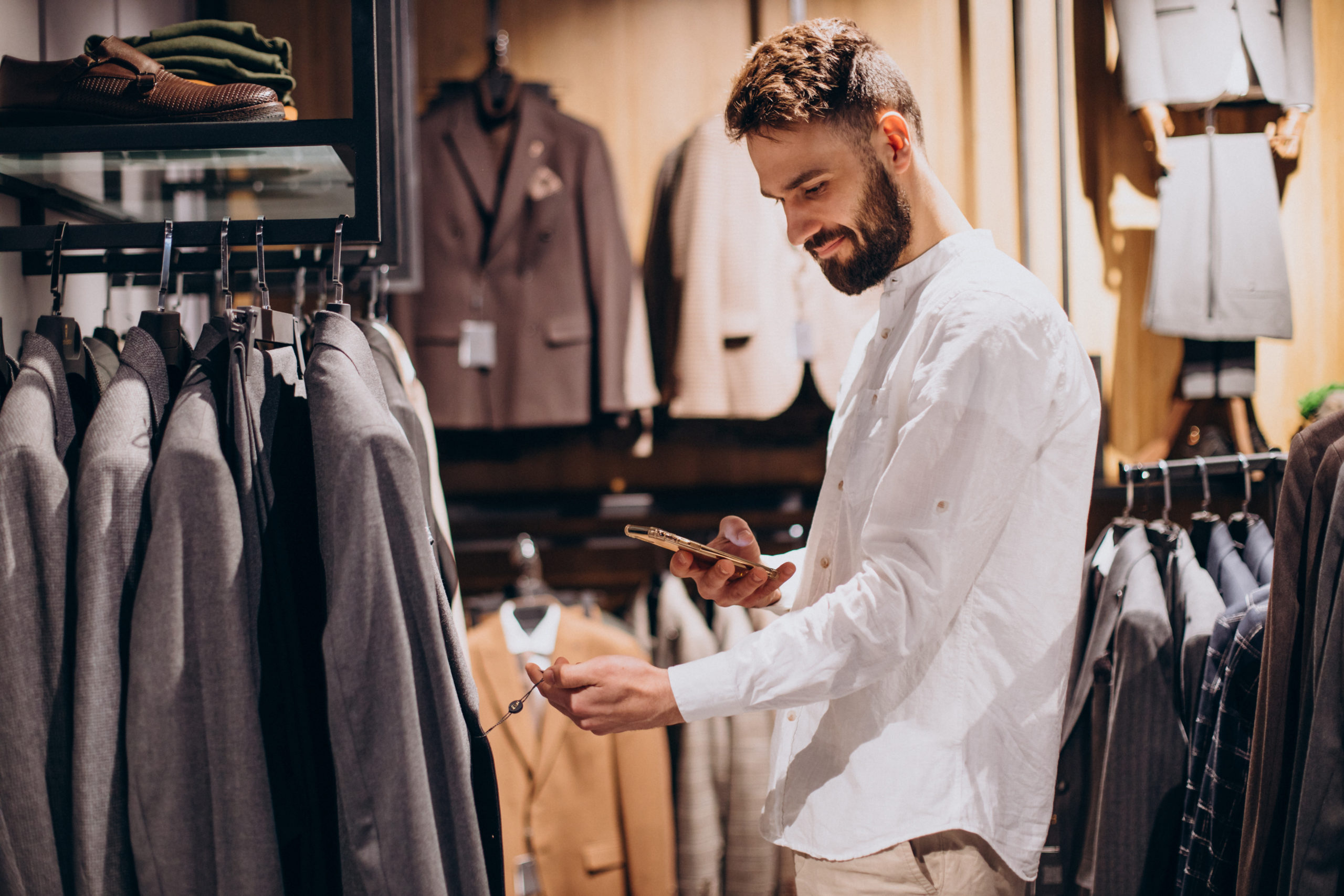 Man scanning qr code with price at mens store